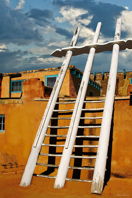 A vividly colored photograph showing an ancient pueblo dwelling at Acoma in New Mexico